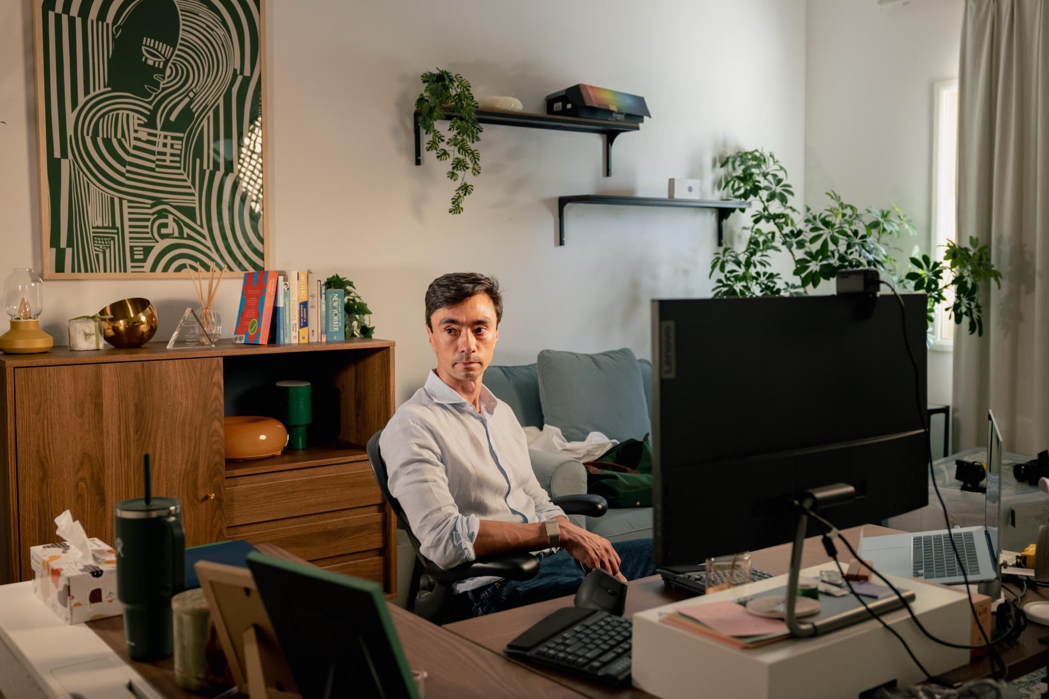 Alex Scott seated at his desk in his home office